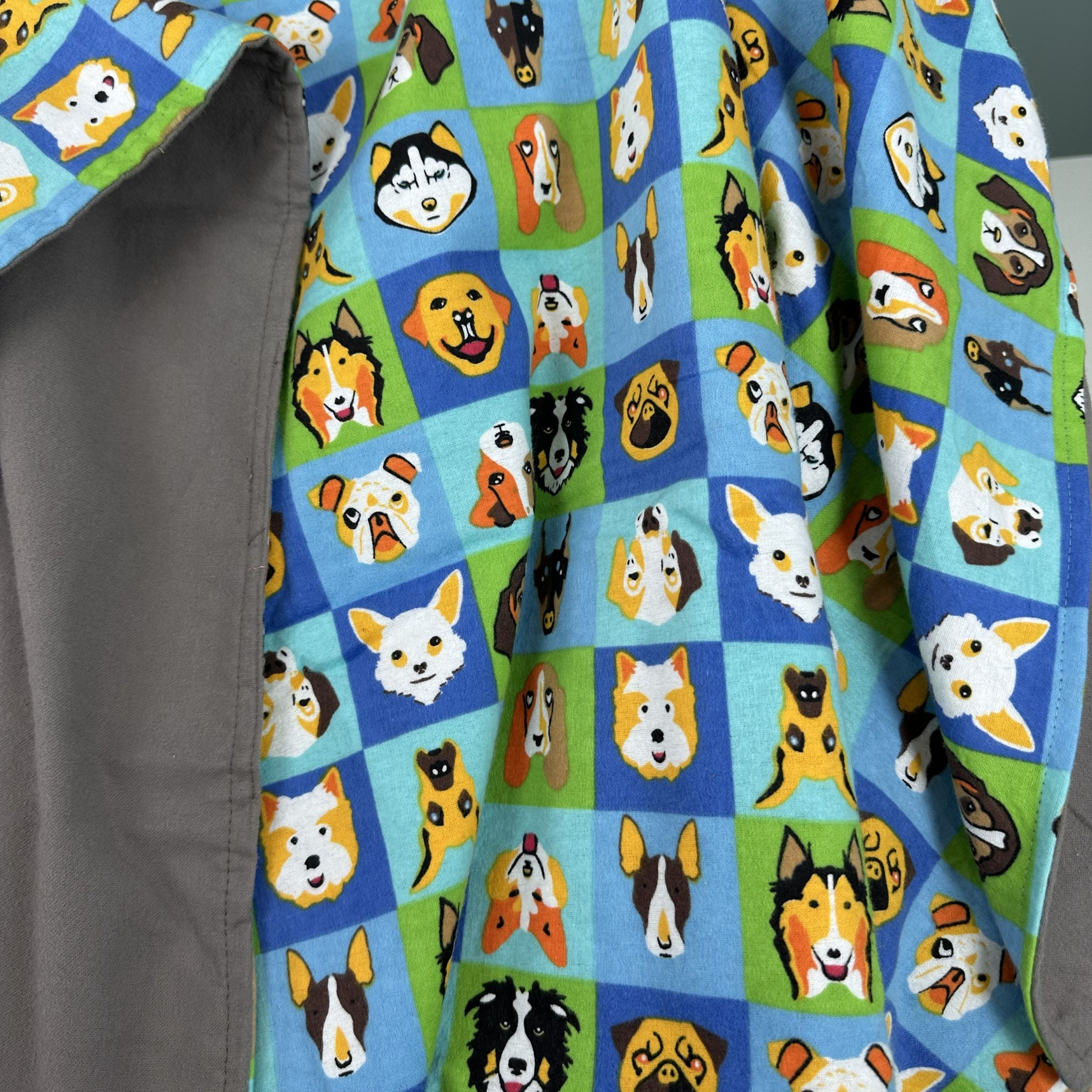 Blue Toby cotton flannel blanket with dog pattern on a blue and green checkered background