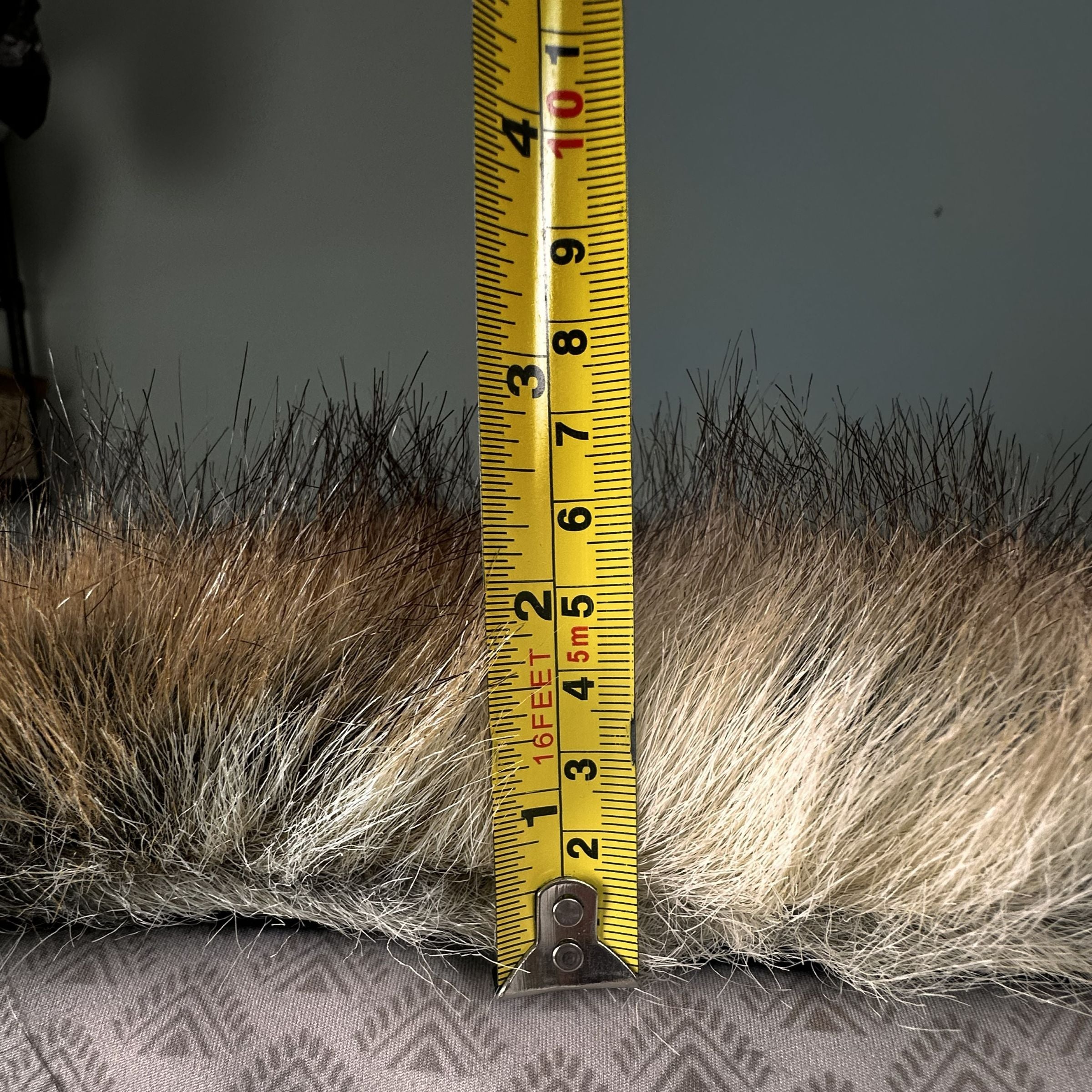 Tape measurer illustrating the length of faux fur at almost 3 inches on the Blue Toby Artic Faux Fur blanket.